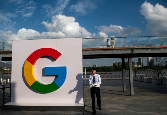 (FILES) In this file photo taken on September 26, 2018 a man passes a Google sign for the World Artificial Intelligence Conference (WAIC) in Shanghai. Google on Monday October 1st, 2018, announced that it will test a video game streaming platform with the release of 