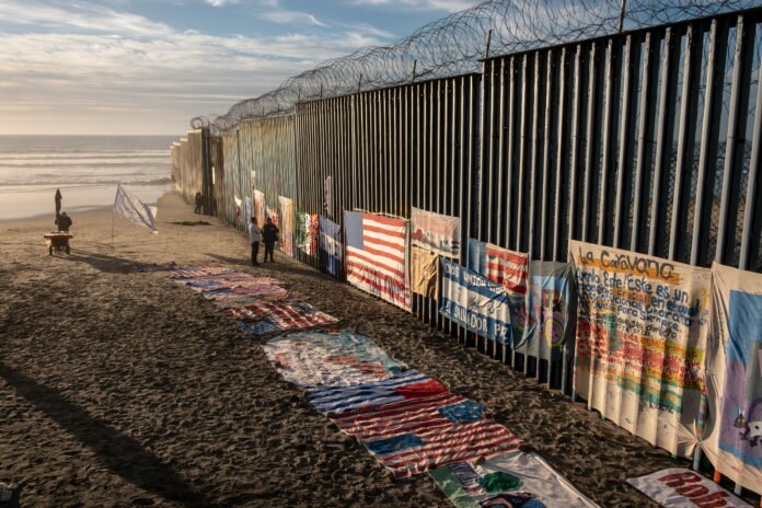An exhibit by local artist Robenz and Central American migrants is on display on the beach next to a section of the US-Mexico border fence as seen from Tijuana, in Baja California state, Mexico, on January 8, 2019. - President Donald Trump tells Americans in a primetime speech Tuesday that the US-Mexico border is in 